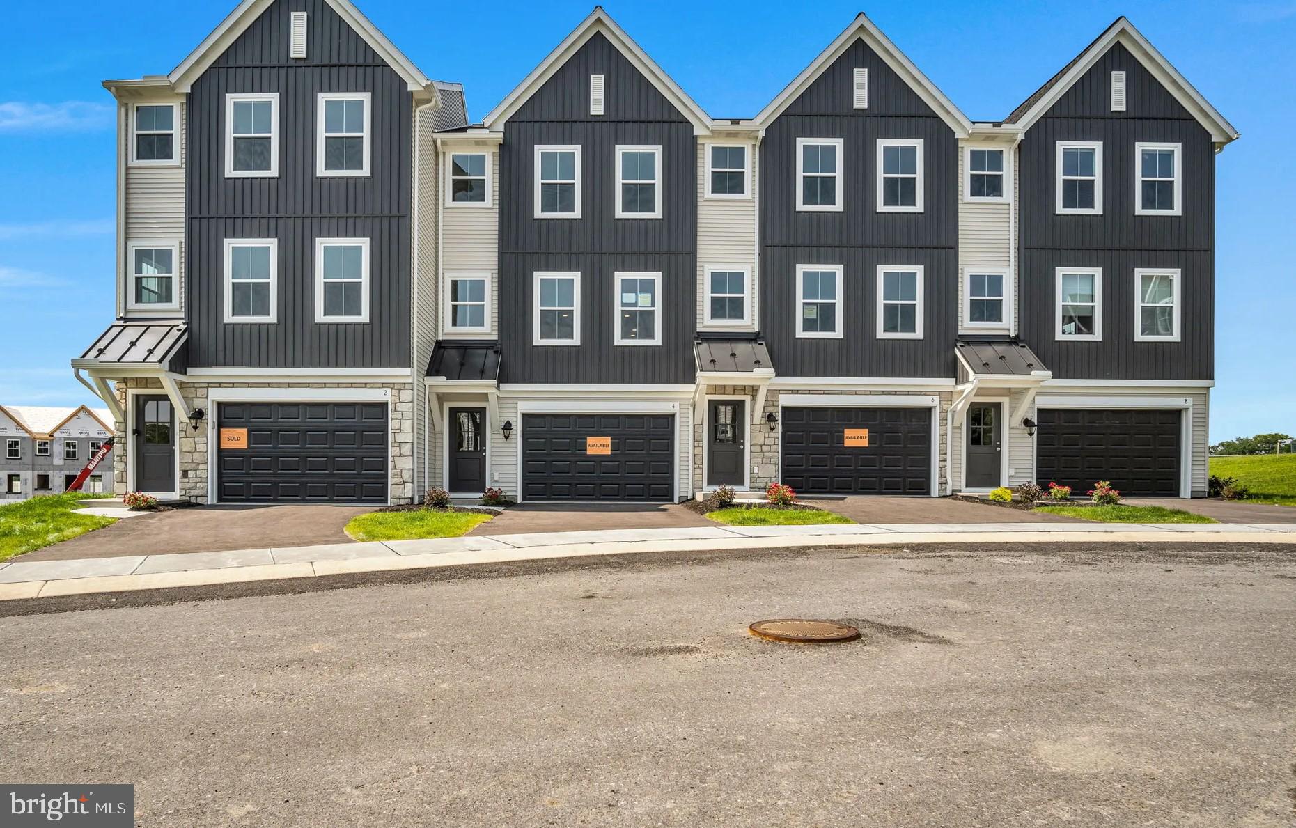 4 Morgan Circle, Unit 1303 Carlisle, PA 17013 - Photo 1 of 13 a front view of a building and a yard