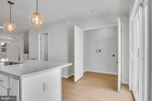a view of a sink and chandelier in a room