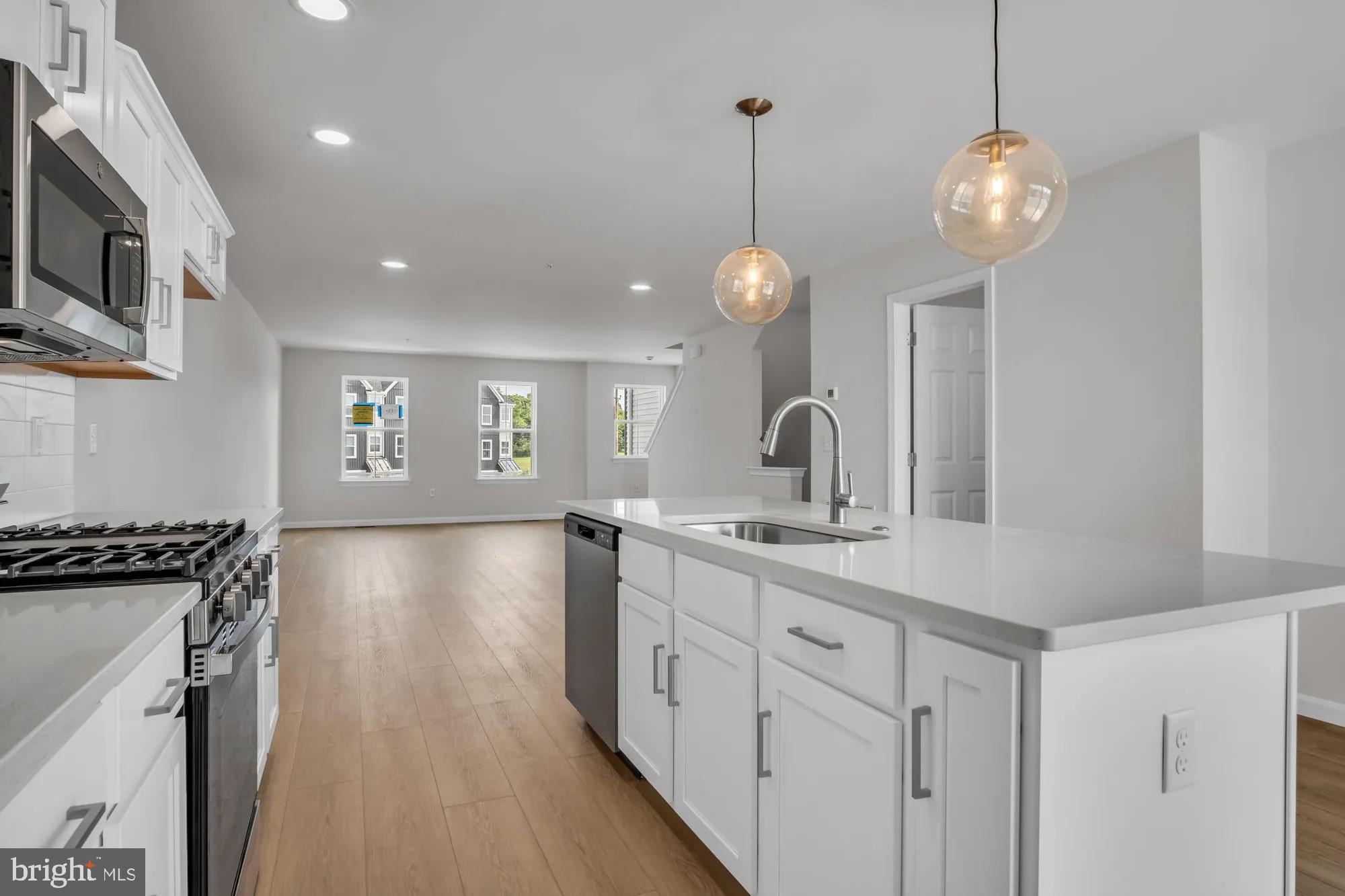 4 Morgan Circle, Unit 1303 Carlisle, PA 17013 - Photo 5 of 13 a kitchen with stainless steel appliances granite countertop a stove and a wooden floors