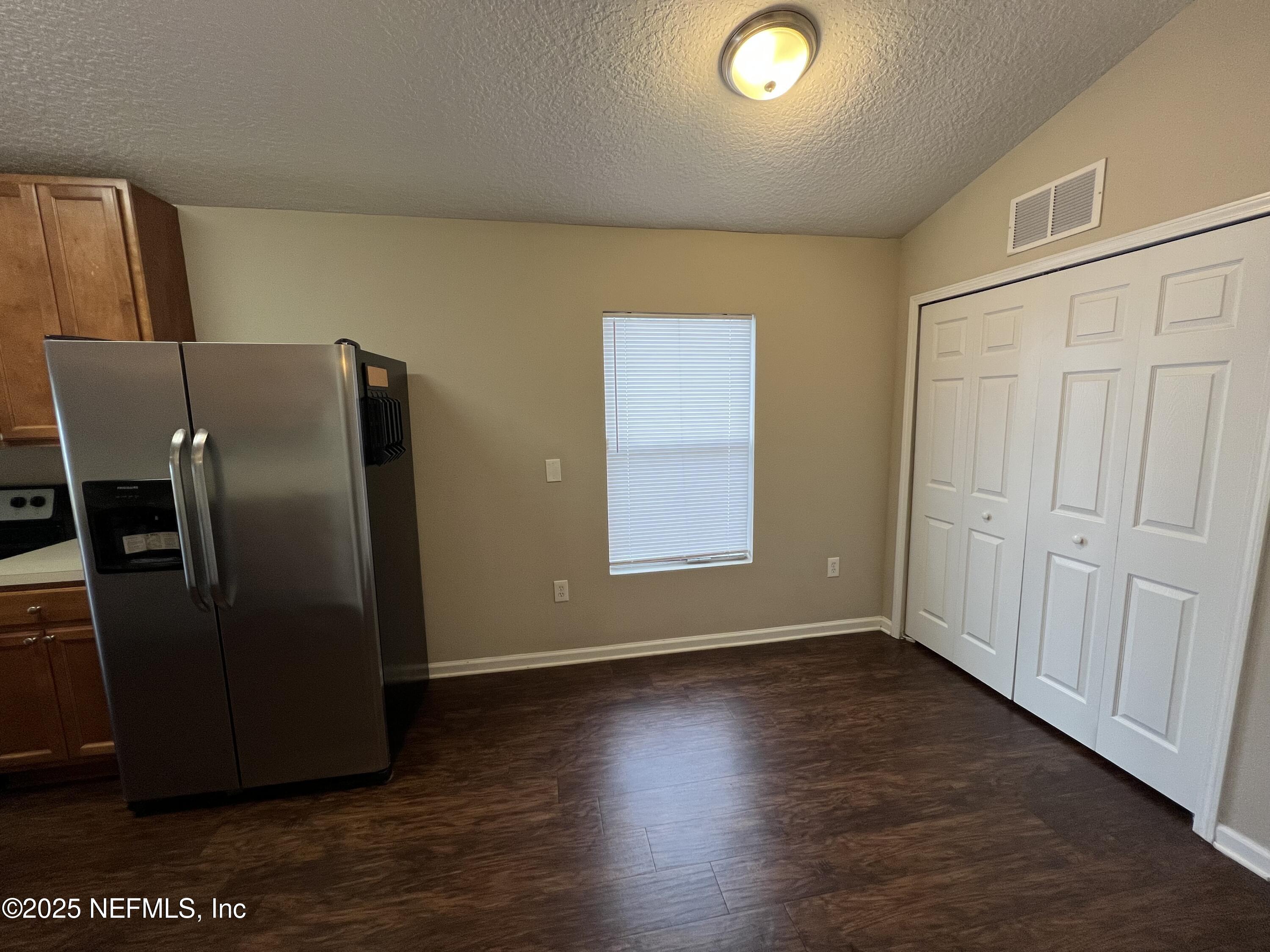 1960 McGirts Point Boulevard Jacksonville, FL 32221 - Photo 6 of 18 a view of a refrigerator in kitchen and wooden floor