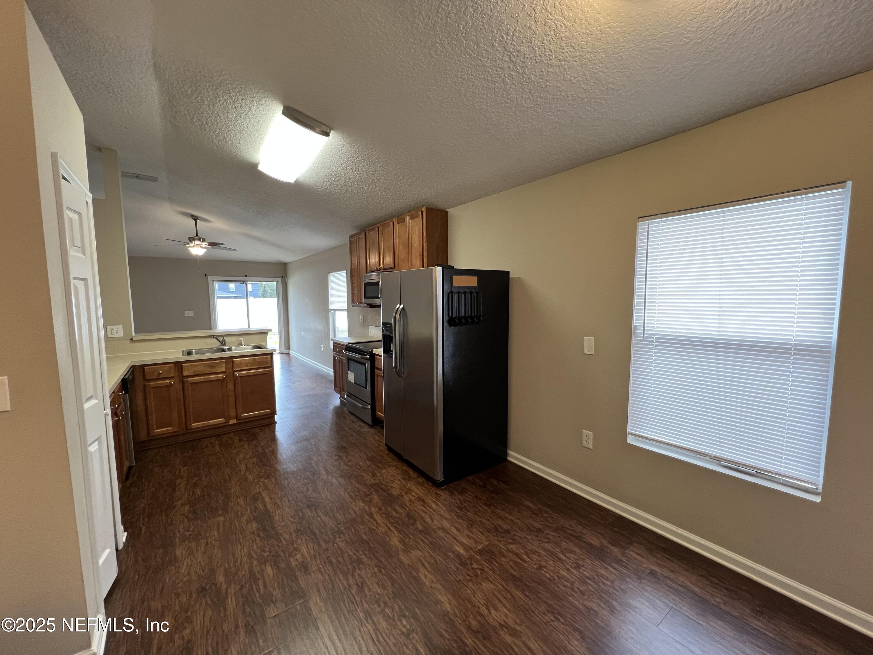 1960 McGirts Point Boulevard Jacksonville, FL 32221 - Photo 8 of 18 a kitchen with a refrigerator and a stove top oven