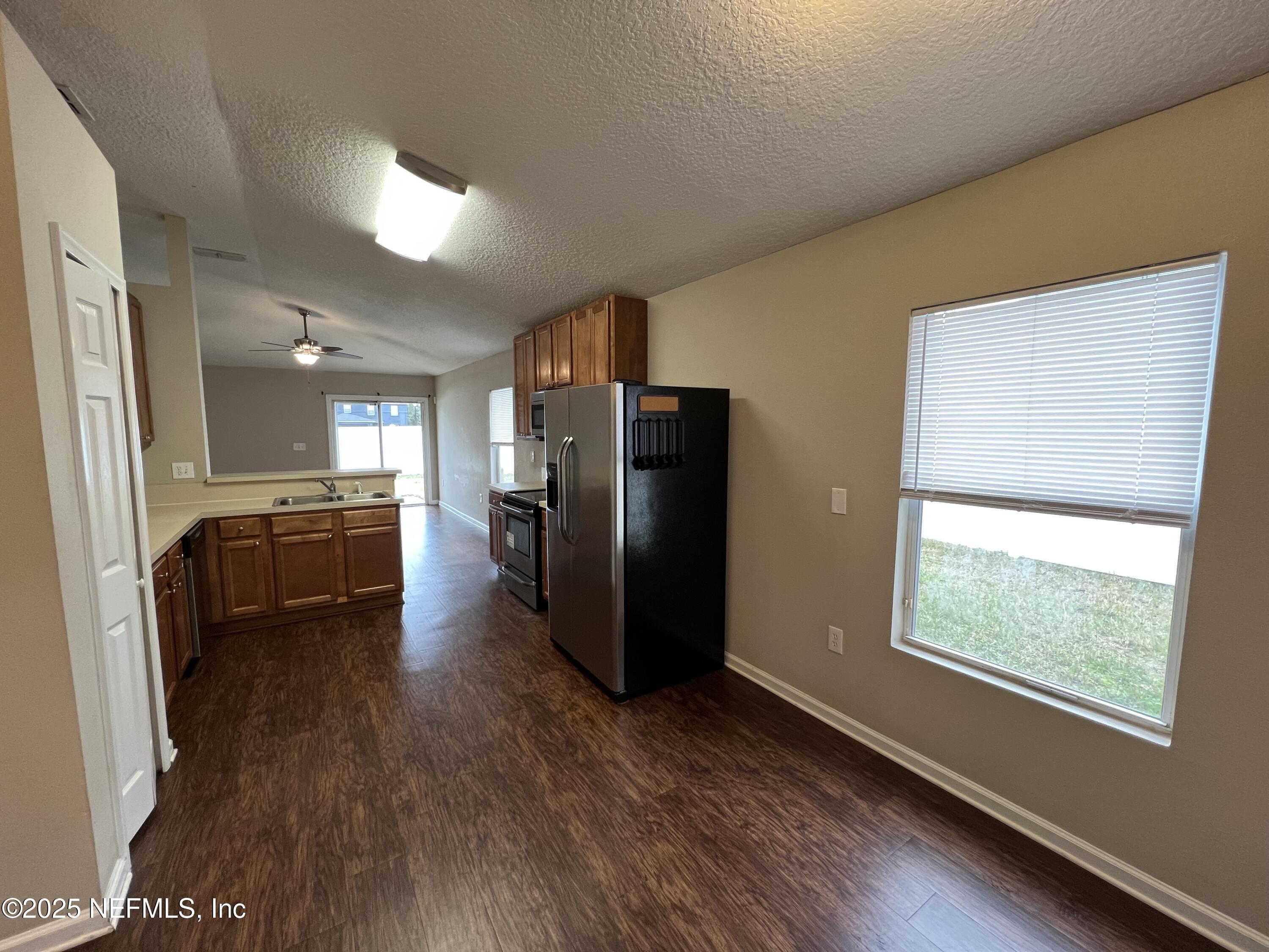 1960 McGirts Point Boulevard Jacksonville, FL 32221 - Photo 9 of 18 a view of a refrigerator in kitchen and a sink