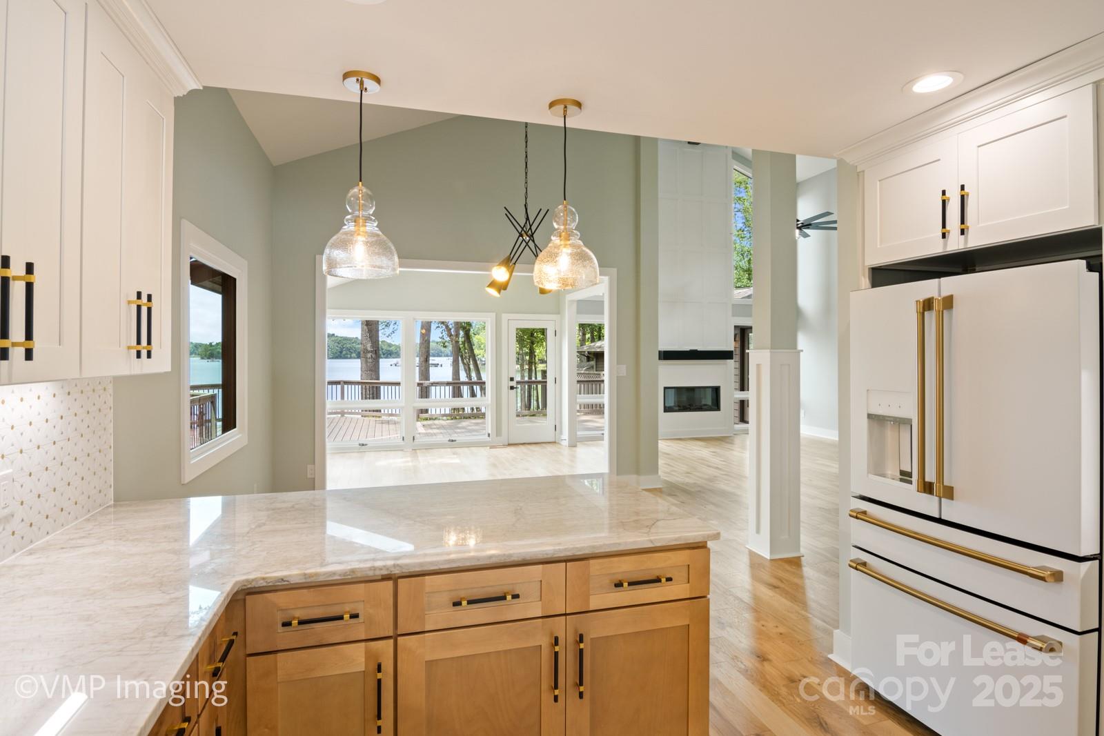 449 Windward Drive Davidson, NC 28036 - Photo 18 of 46 a kitchen with granite countertop a refrigerator and a sink