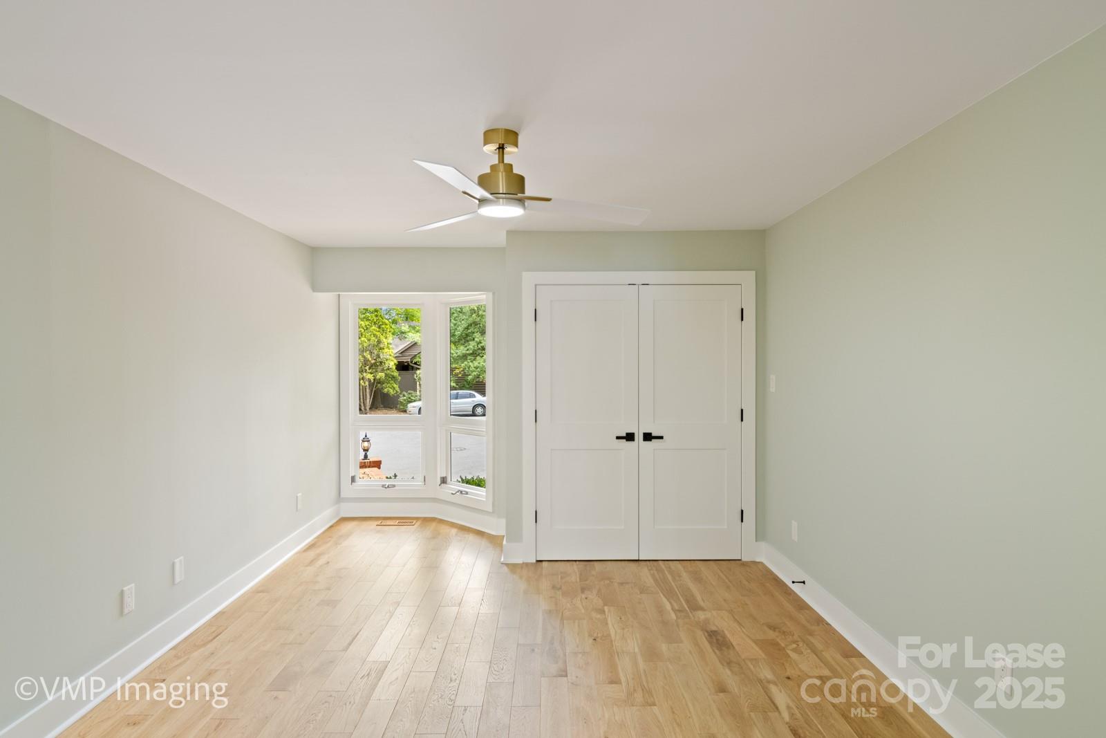 449 Windward Drive Davidson, NC 28036 - Photo 20 of 46 a view of an empty room with window and wooden floor