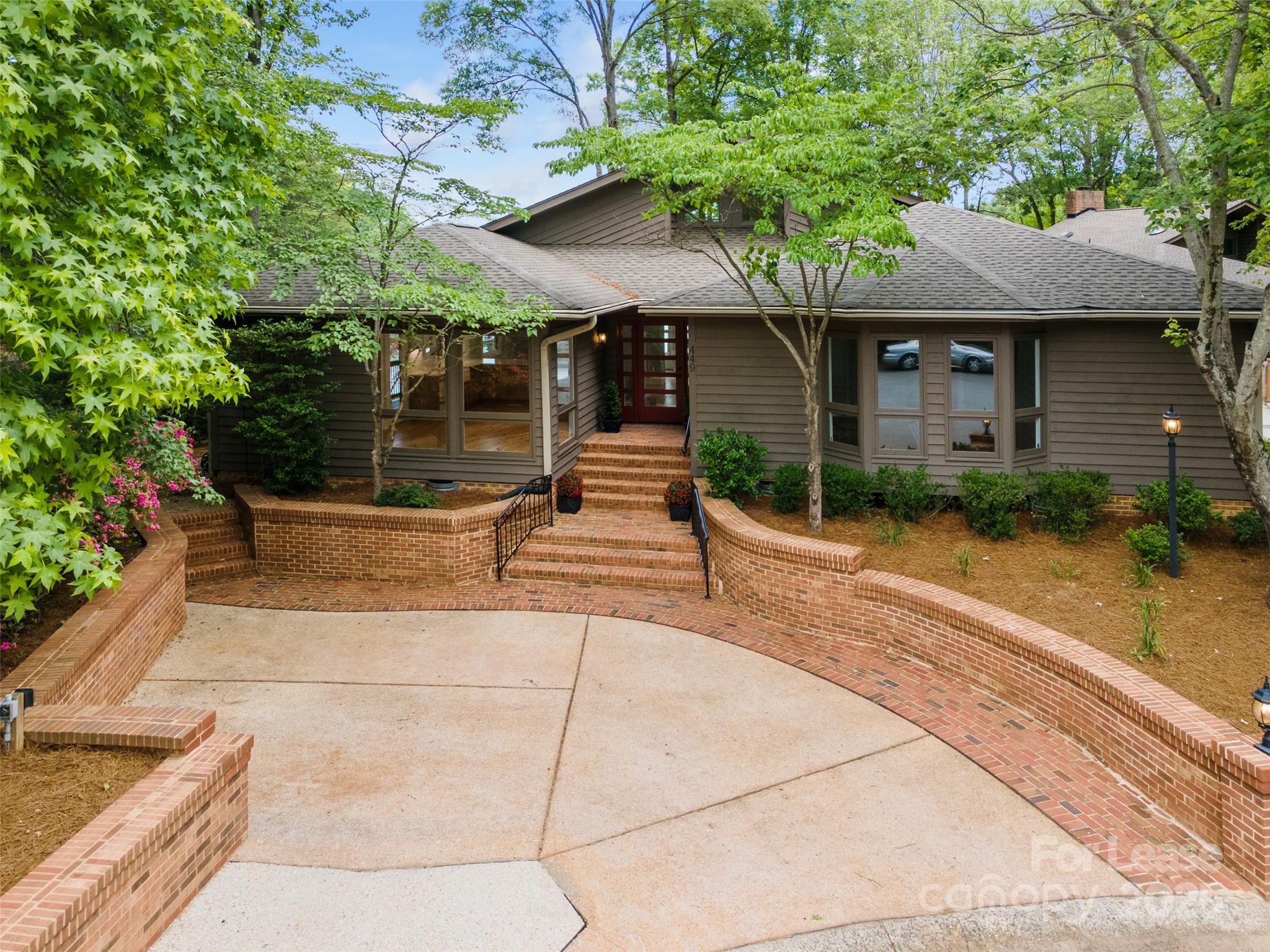 449 Windward Drive Davidson, NC 28036 - Photo 2 of 46 a front view of a house with garden