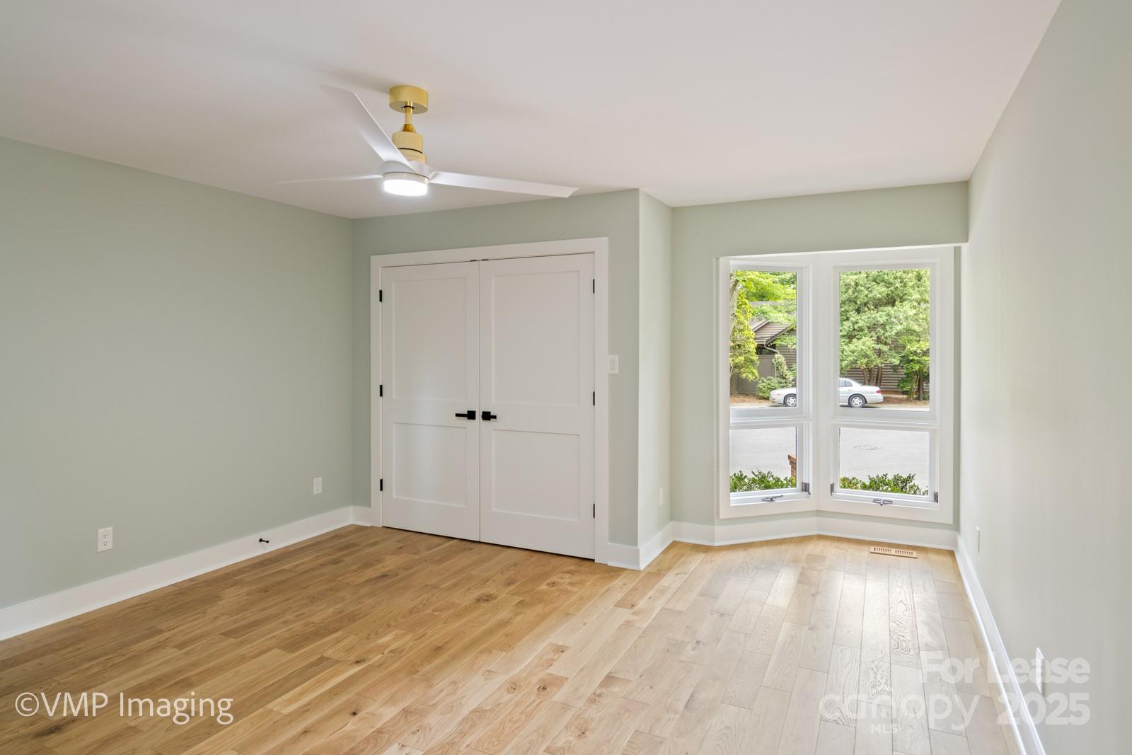 449 Windward Drive Davidson, NC 28036 - Photo 21 of 46 wooden floor in an empty room with a window