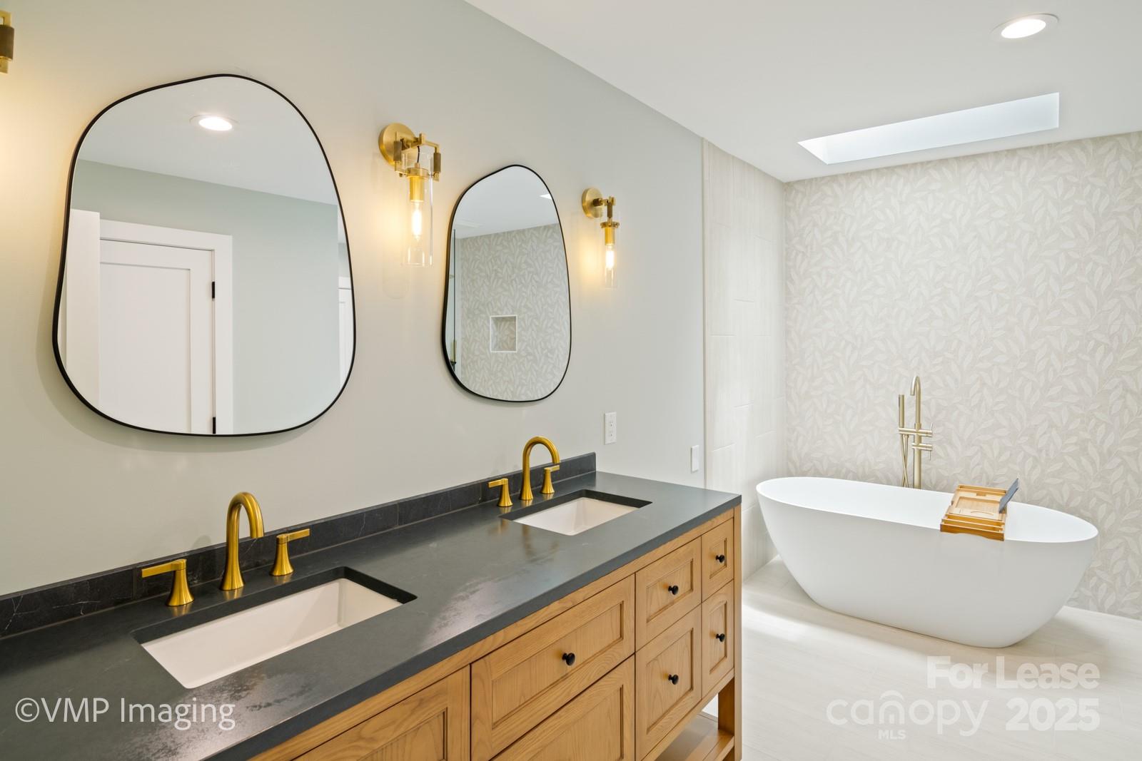 449 Windward Drive Davidson, NC 28036 - Photo 25 of 46 a bathroom with a double vanity sink and a mirror