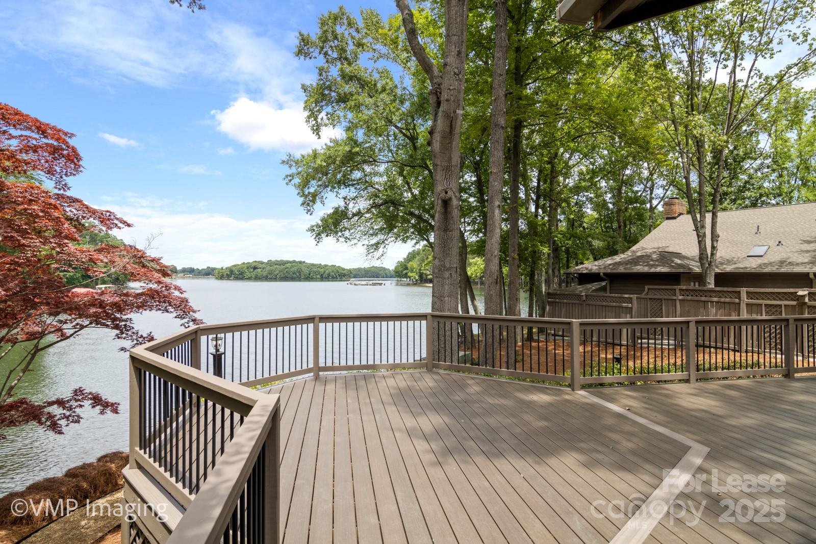 449 Windward Drive Davidson, NC 28036 - Photo 38 of 46 a view of a roof deck with wooden floor and fence
