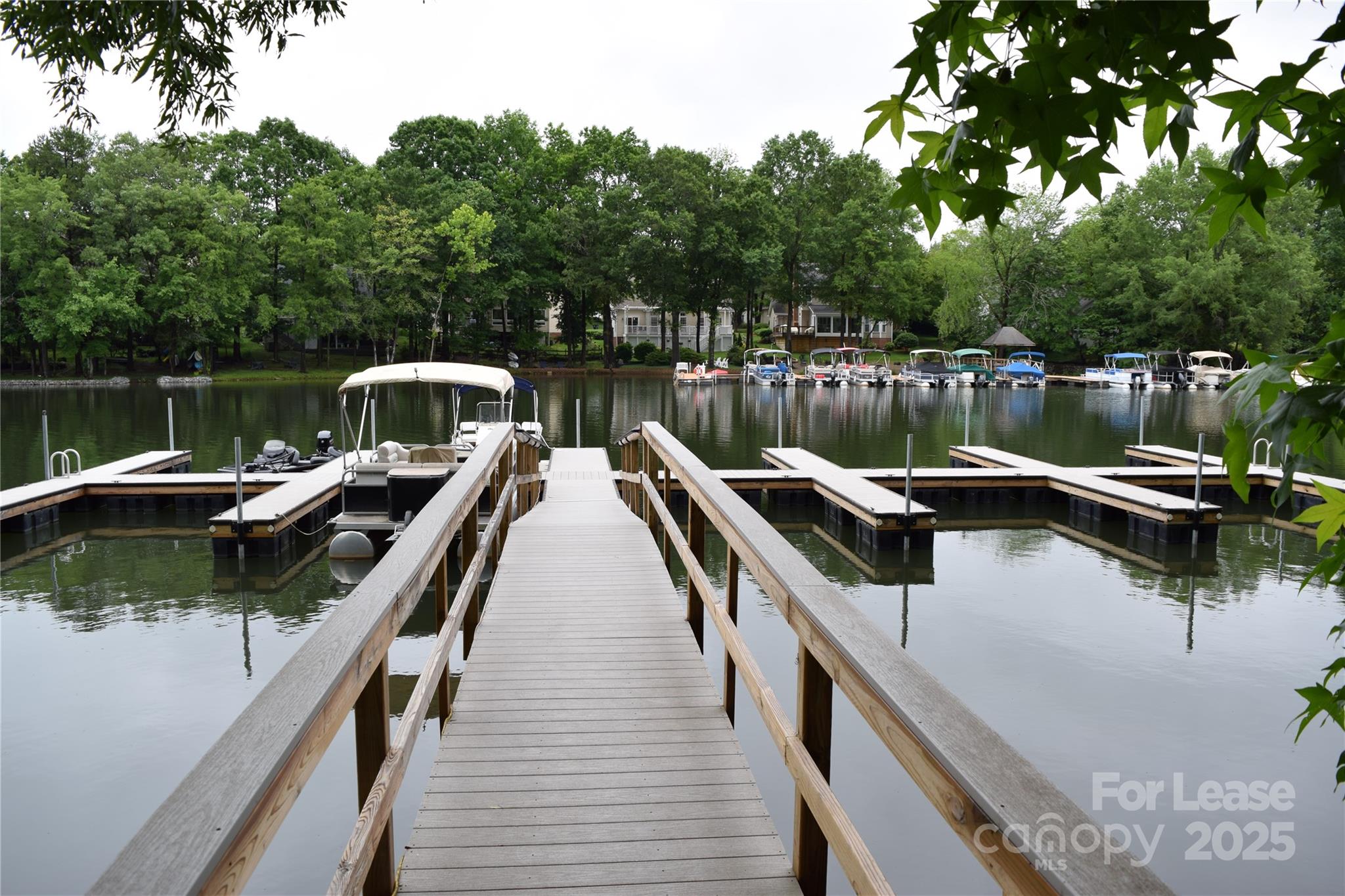 449 Windward Drive Davidson, NC 28036 - Photo 43 of 46 a view of a lake with boats and trees in the background