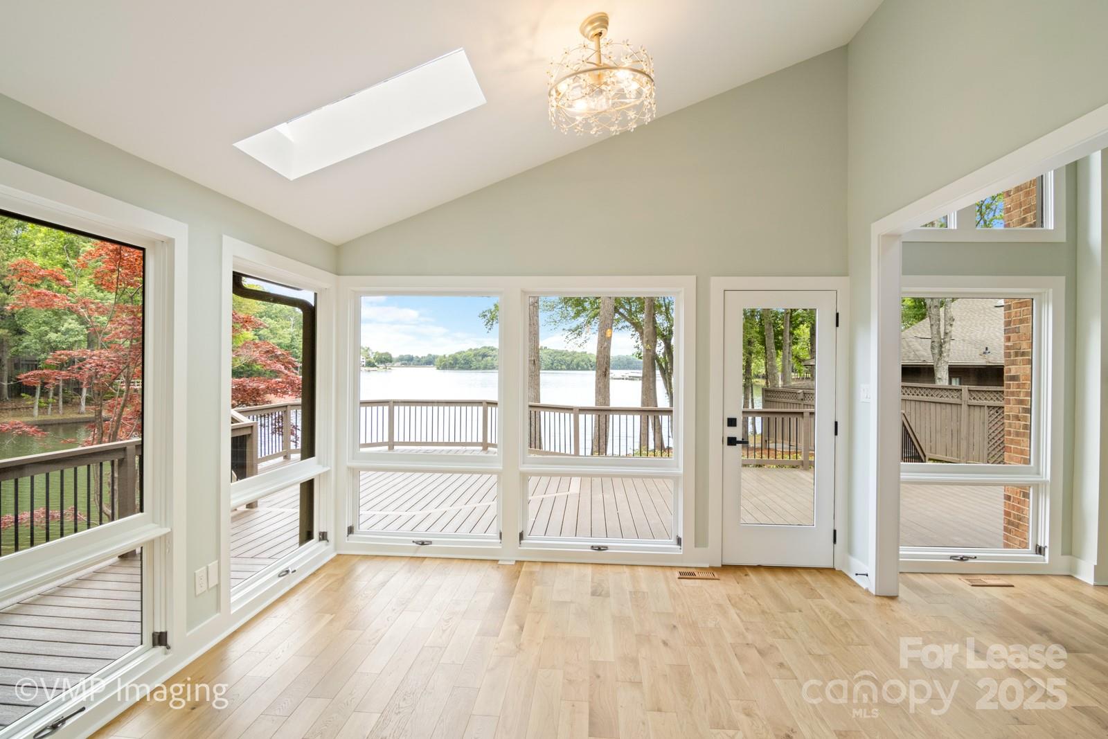 449 Windward Drive Davidson, NC 28036 - Photo 9 of 46 an empty room with wooden floor and windows