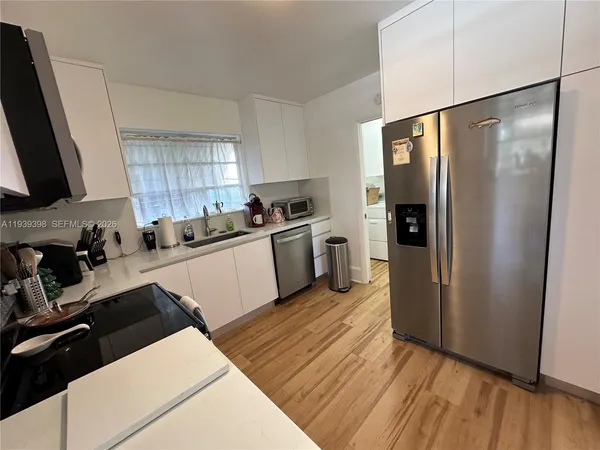a kitchen with stainless steel appliances granite countertop a sink a stove a microwave and cabinets