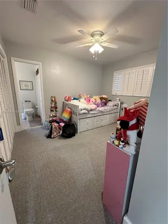 a bedroom with bed and a chandelier