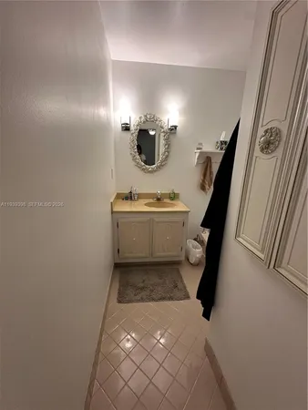 a bedroom with bed and a chandelier