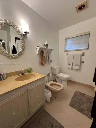 a bedroom with a bed and a ceiling fan