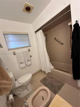 a bedroom with bed and a chandelier