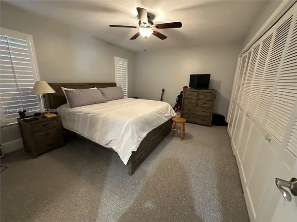 a view of a hallway and a livingroom with furniture