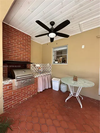 a view of a white house with a yard