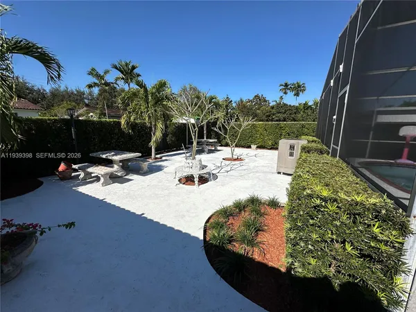 a view of a backyard with plants and patio