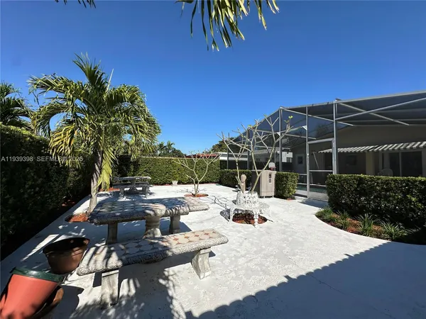 a view of a backyard with sitting area