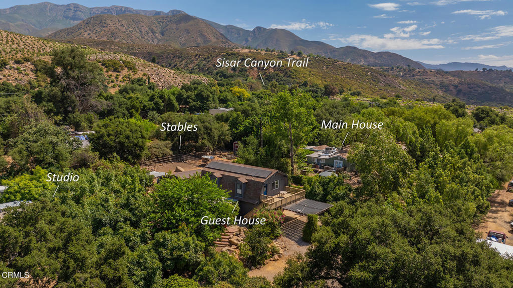 12605-12607 Sisar Road Ojai, CA 93023 - Photo 1 of 1 a view of a lush green hillside and houses