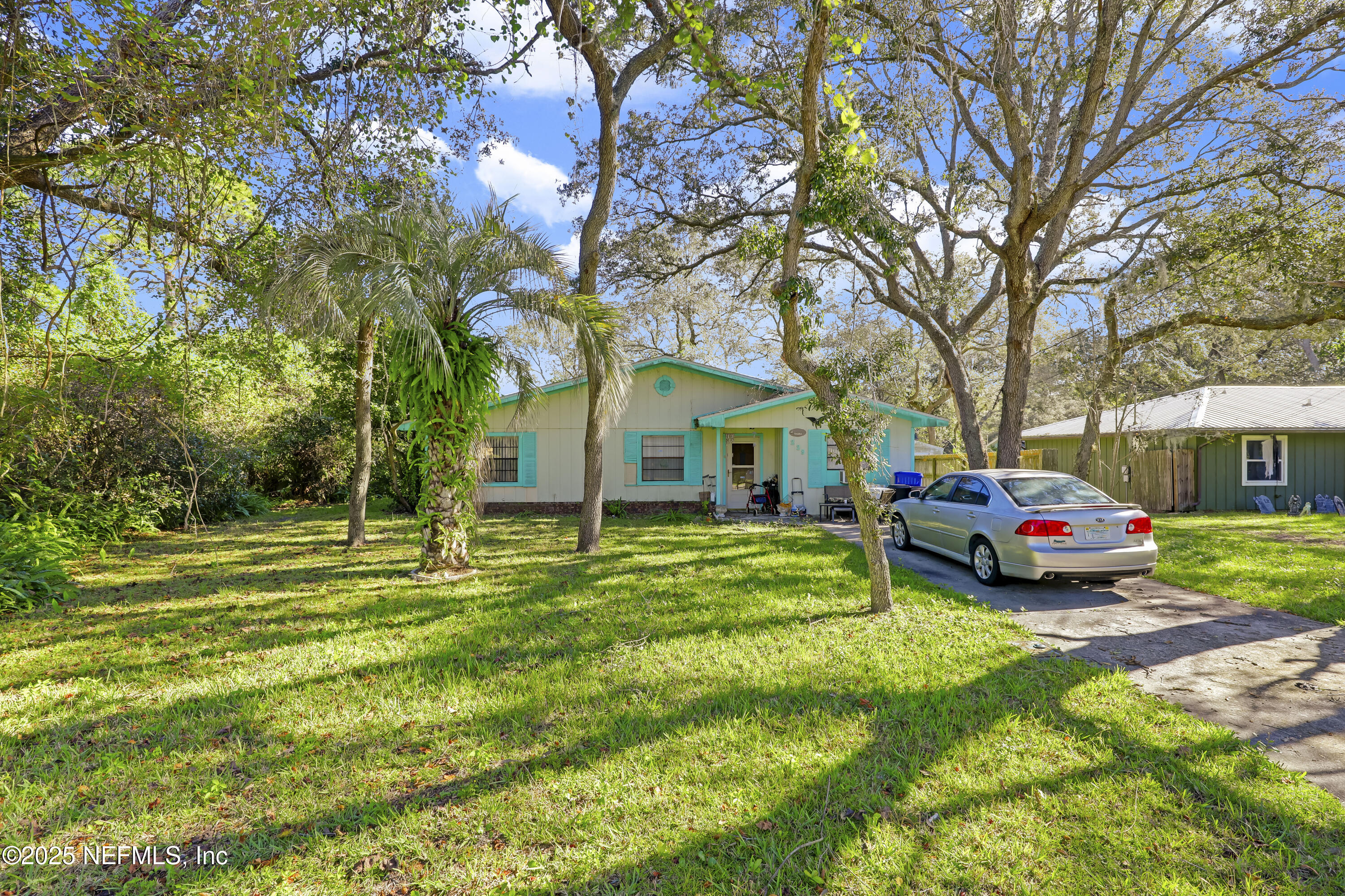 229 Bonita Road St. Augustine, FL 32086 - Photo 1 of 9 a front view of a house with garden and trees