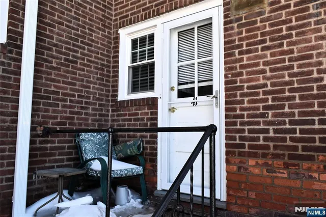 a view of a building with snow on the road