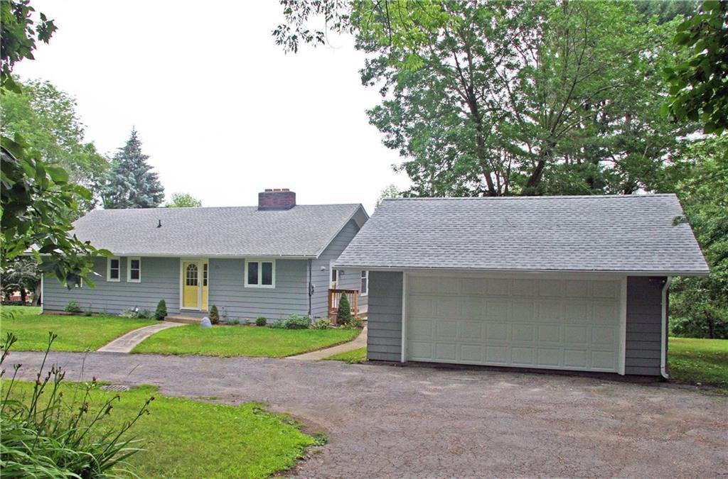 21 Weed Road Torrington, CT 06790 - Photo 1 of 1 a front view of a house with a garden and plants