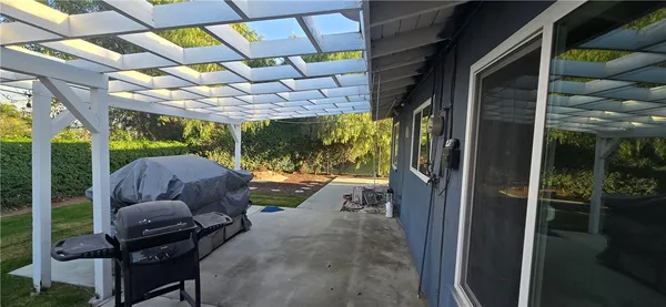 a view of a porch with furniture and a yard