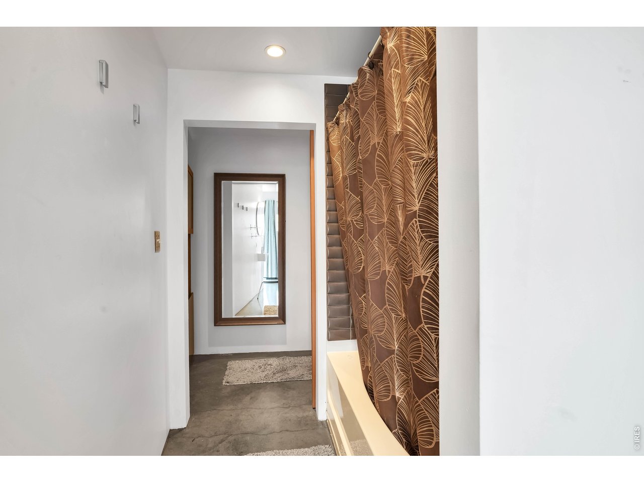 3457 Ringsby Court, Unit 327 Denver, CO 80216 - Photo 15 of 29 a view of a bathroom from a hallway