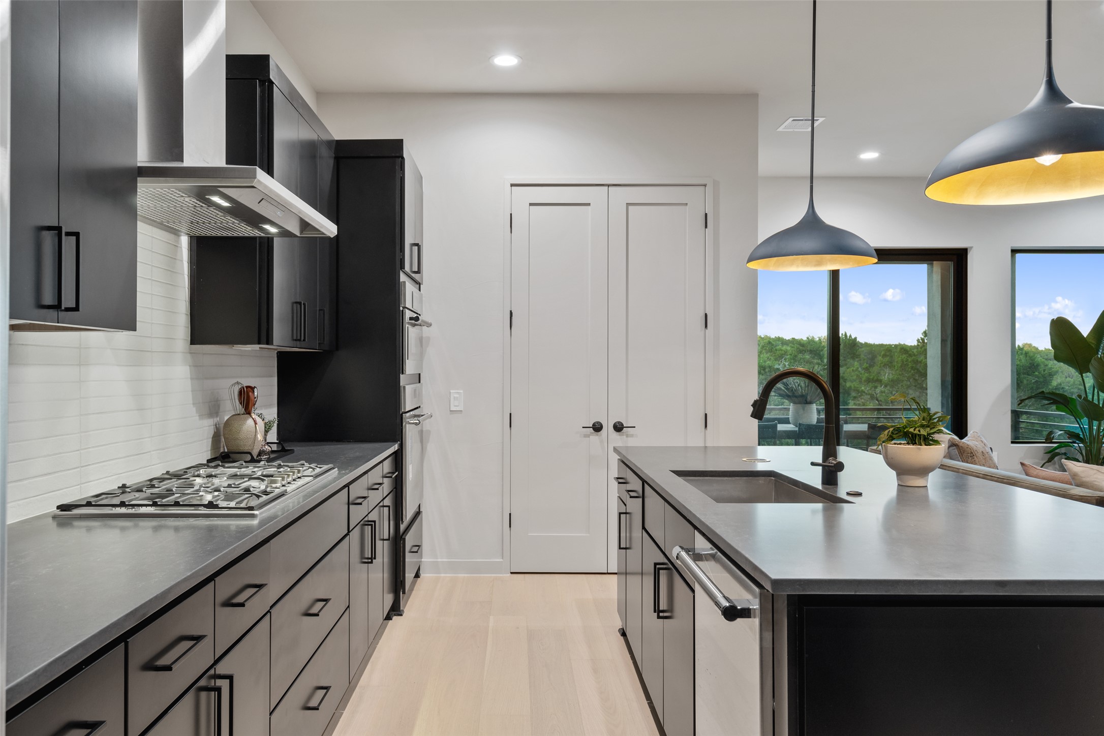 9803 Ribelin Ranch Court, Unit 6 Austin, TX 78750 - Photo 5 of 31 A contemporary kitchen featuring abundant cabinet storage and sleek countertops.
