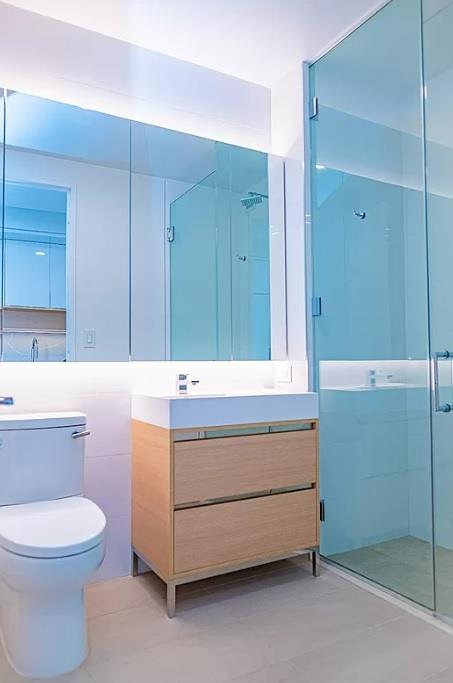 20 Broad Street, Unit 1513 Manhattan, NY 10005 - Photo 1 of 3 a bathroom with a sink a toilet and mirror