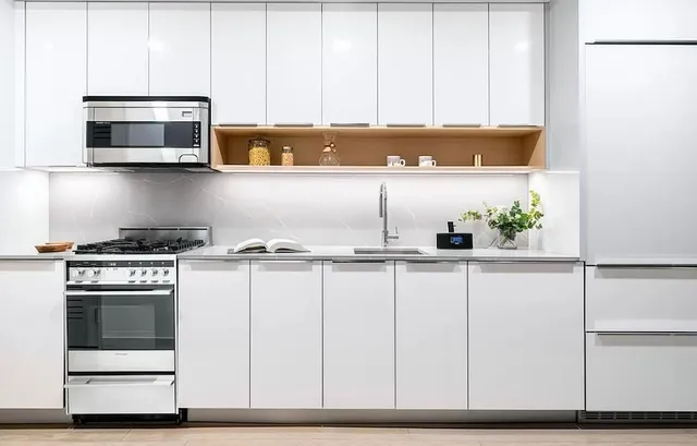a kitchen with stainless steel appliances a stove a microwave and cabinets