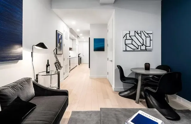 a living room with furniture and wooden floor