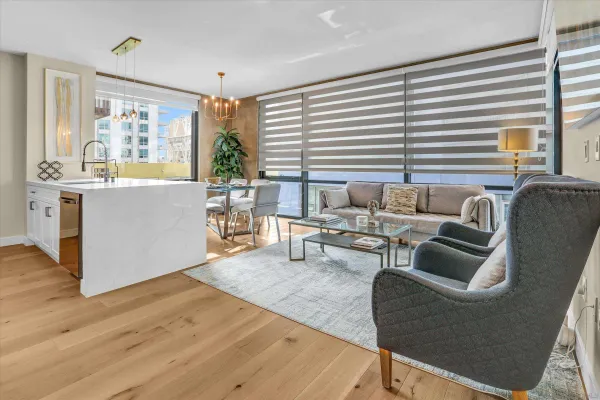 a living room with furniture and wooden floor