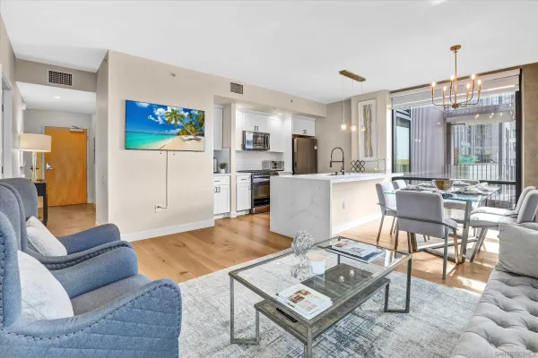 a living room with furniture and kitchen view
