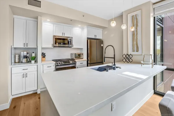 a kitchen with stainless steel appliances a sink stove and refrigerator