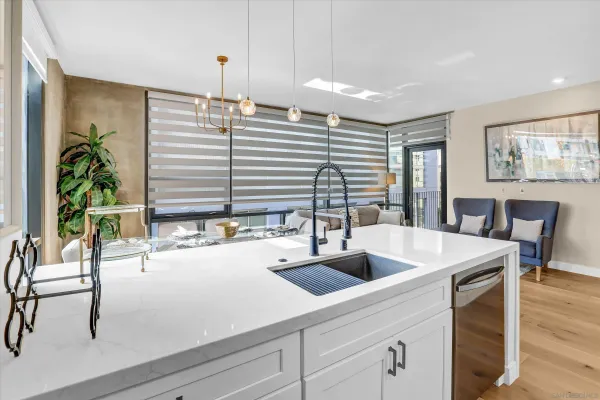a kitchen with a table chairs and a window