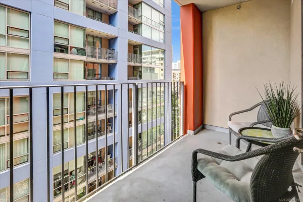 a balcony with furniture and a potted plant