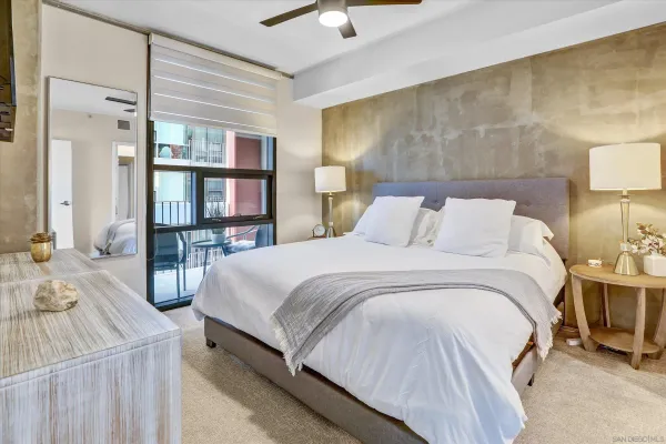 a bedroom with a bed and a lamp on table