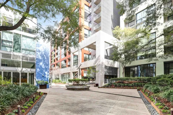 a view of a building with a bench and potted plants