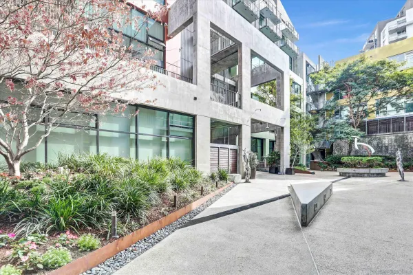 a view of a building with garden and sitting area