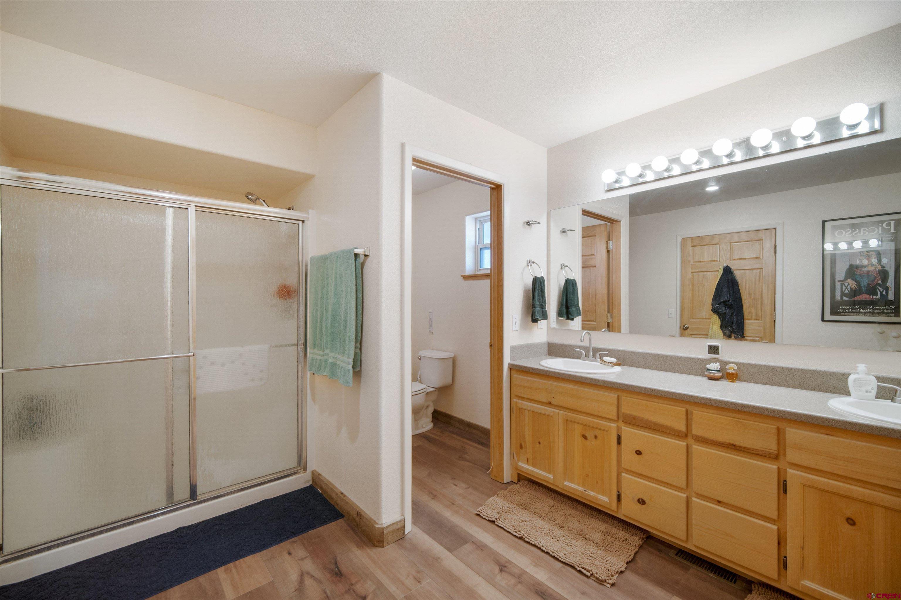 660 Road 8k Egnar, CO 81325 - Photo 11 of 30 a spacious bathroom with a double vanity sink a mirror and a shower