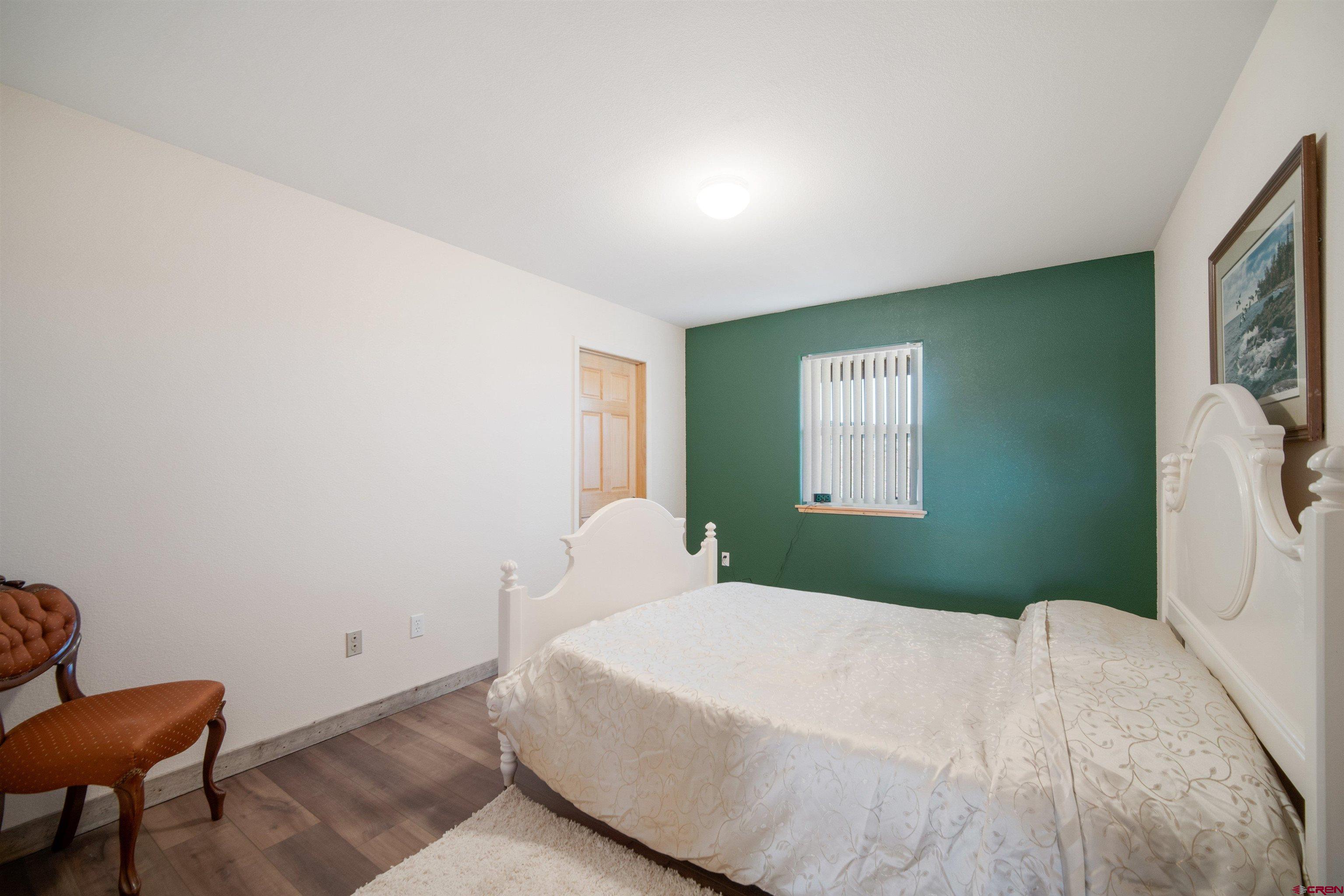 660 Road 8k Egnar, CO 81325 - Photo 14 of 30 a bedroom with a bed and a chair