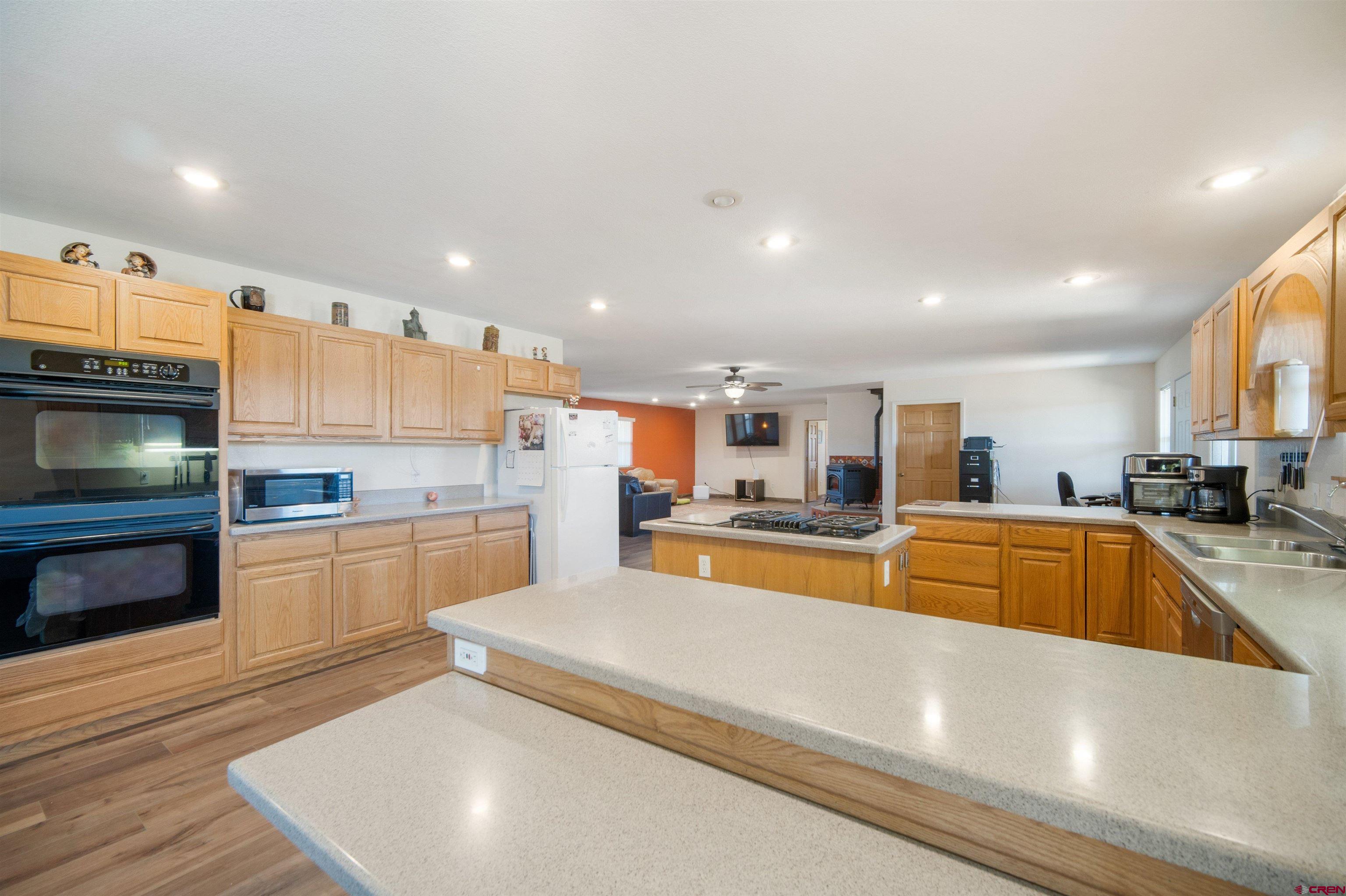 660 Road 8k Egnar, CO 81325 - Photo 17 of 30 a large kitchen with stainless steel appliances granite countertop a stove and a sink with granite countertops