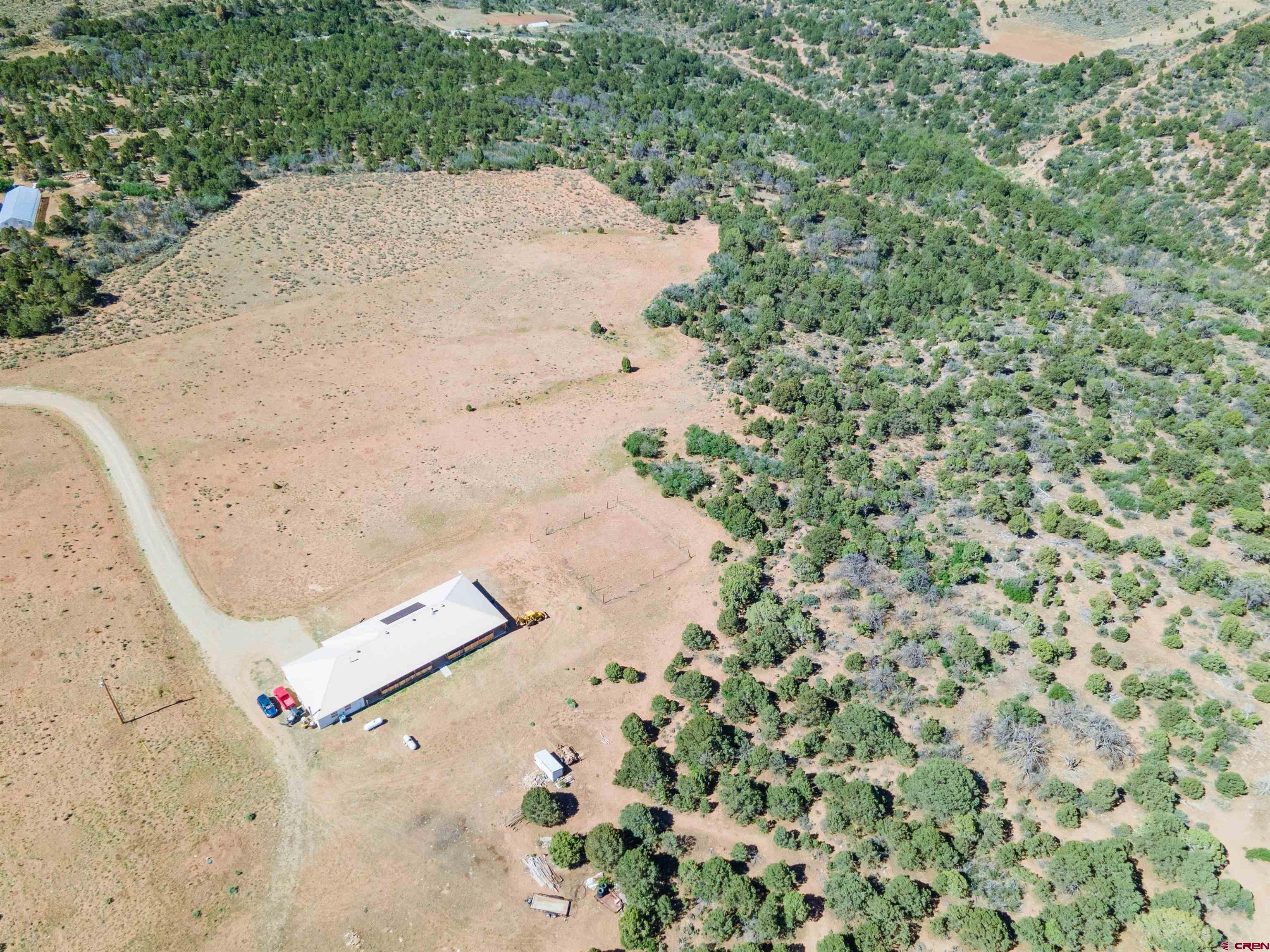 660 Road 8k Egnar, CO 81325 - Photo 26 of 30 an aerial view of a house with a yard and trees