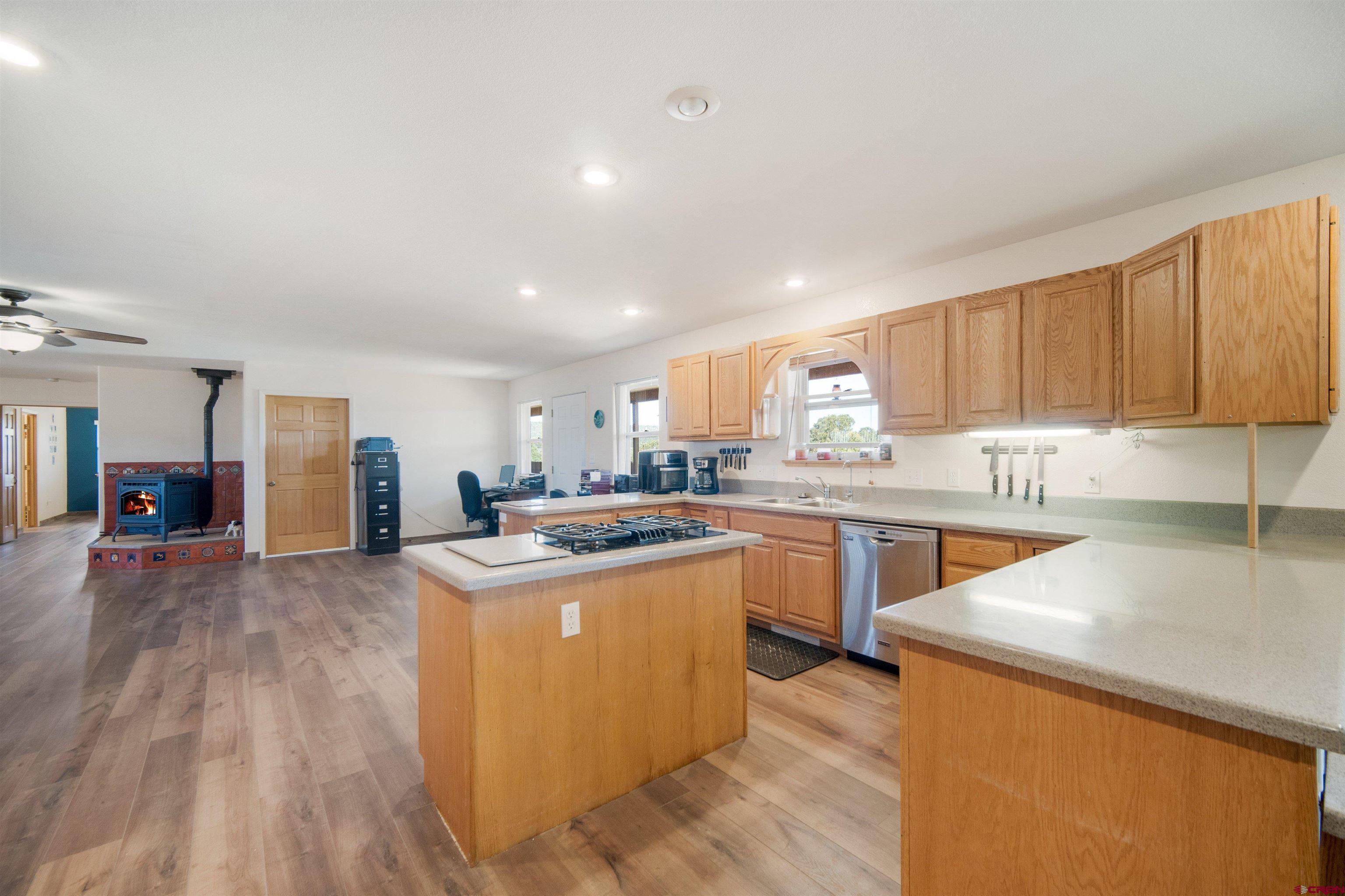 660 Road 8k Egnar, CO 81325 - Photo 4 of 30 a kitchen with stainless steel appliances granite countertop a sink and cabinets