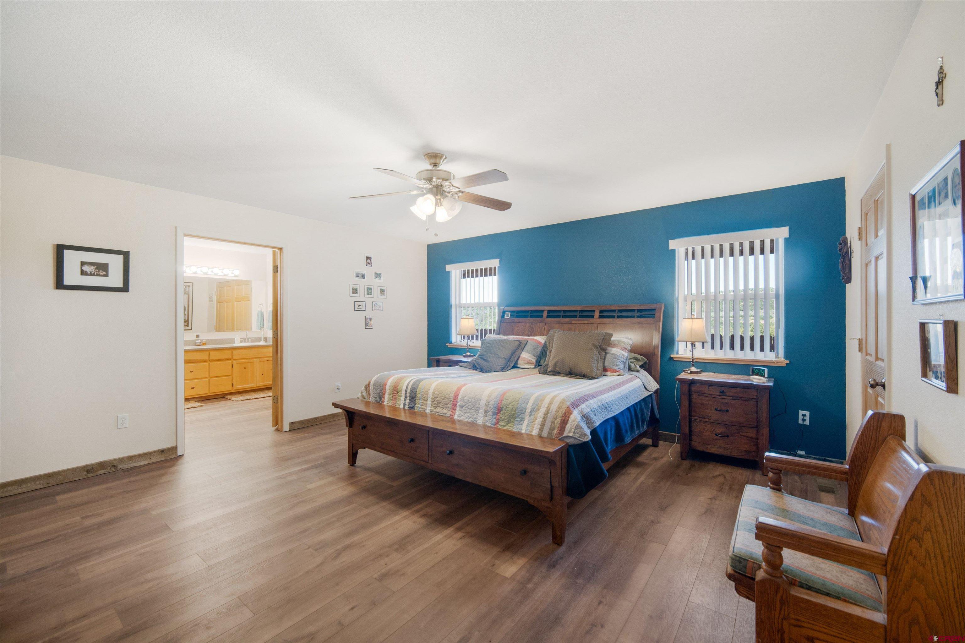 660 Road 8k Egnar, CO 81325 - Photo 9 of 30 a spacious bedroom with a bed and wooden floor