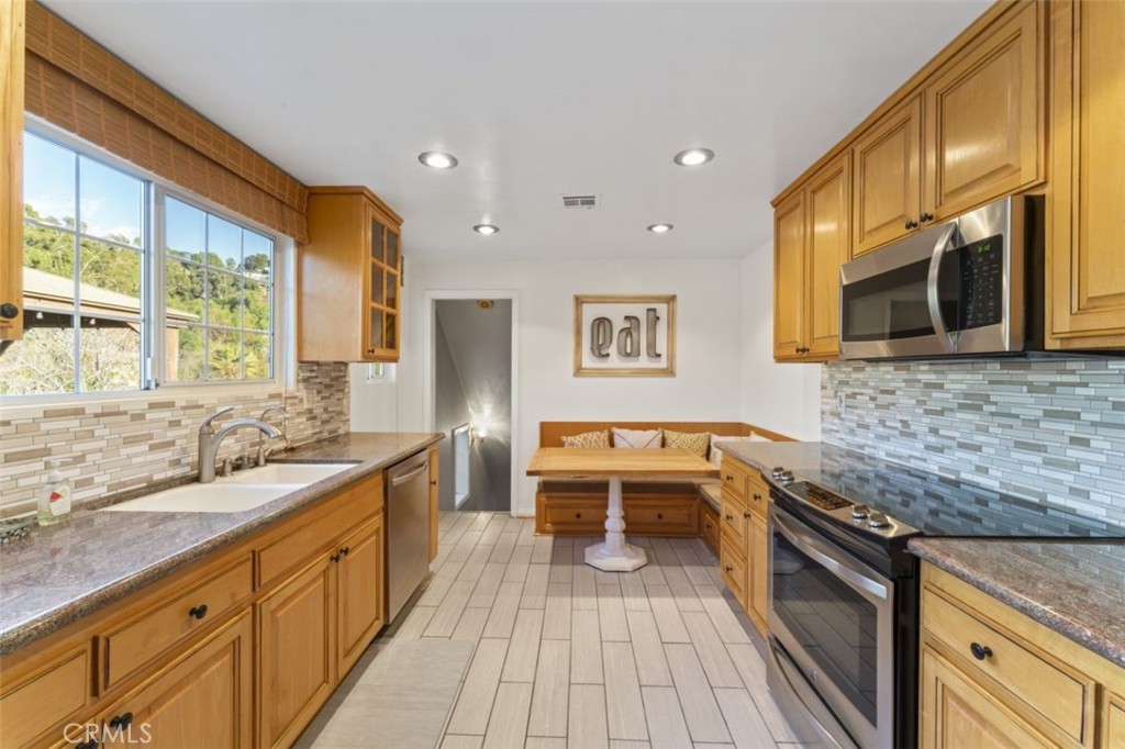 7223 Tranquil Place Tujunga, CA 91042 - Photo 11 of 40 a kitchen with stainless steel appliances granite countertop a sink stove and oven