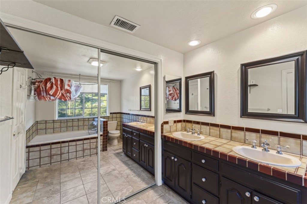 7223 Tranquil Place Tujunga, CA 91042 - Photo 20 of 40 a bathroom with double vanity sinks double vanity tub shower and a mirror