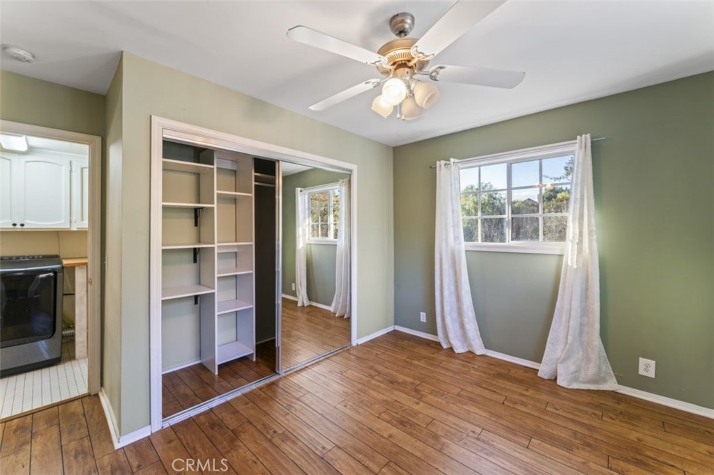 7223 Tranquil Place Tujunga, CA 91042 - Photo 25 of 40 an empty room with wooden floor cabinet and windows